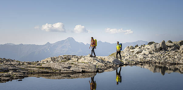 Weitwandern am Tauernhoehenweg entlang eines Bergsees